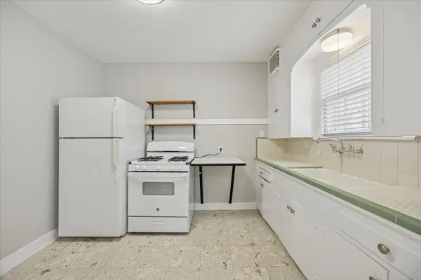 a kitchen with a stove sink and refrigerator