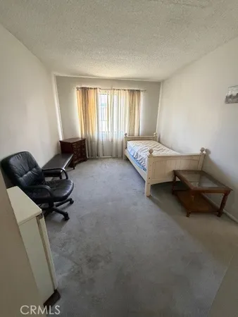 a bedroom with bed and a window