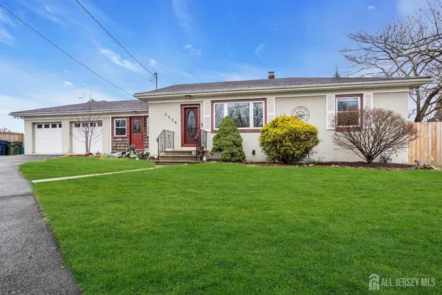 a front view of a house with garden and porch