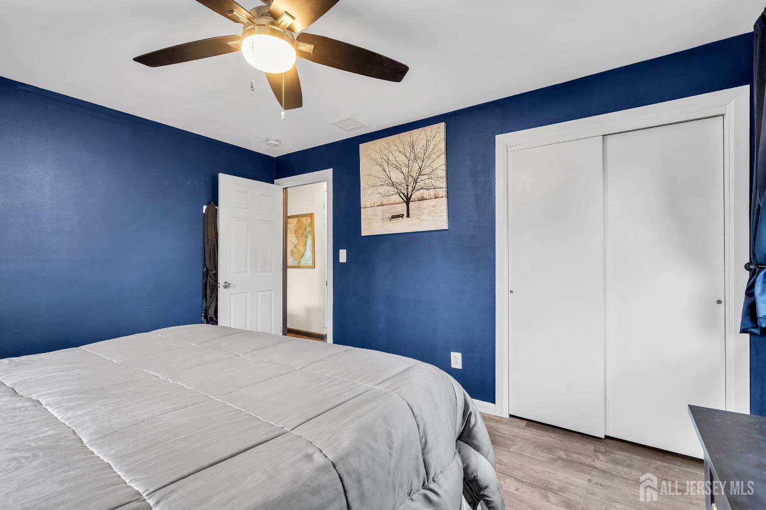 505 Summit Street Hightstown, NJ 08520 - Photo 11 of 30 a bedroom with a large bed window and a chandelier