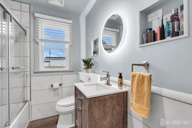 a bathroom with a toilet sink and mirror