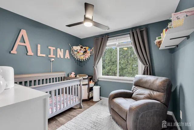 a bedroom with furniture and a large window