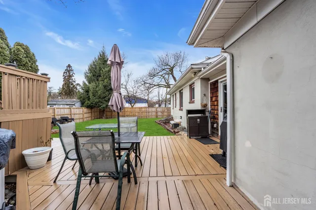 a view of a patio with table and chairs couches with wooden floor and fence
