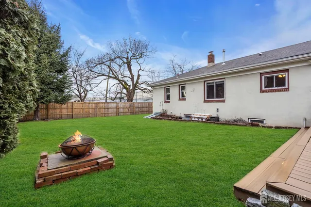 a backyard of a house with table and chairs