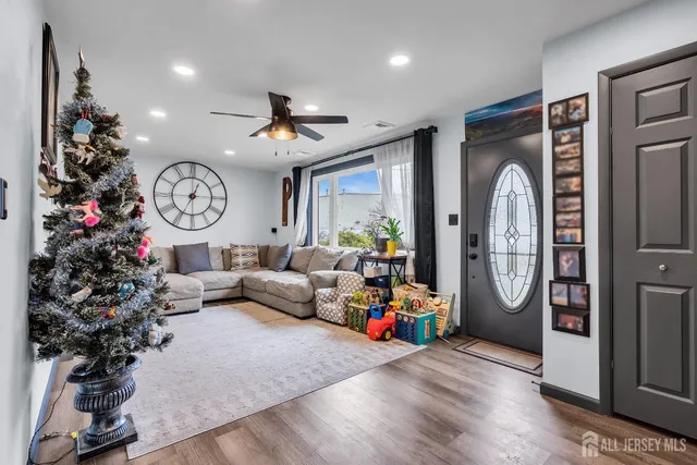 a living room with furniture a clock and a large window