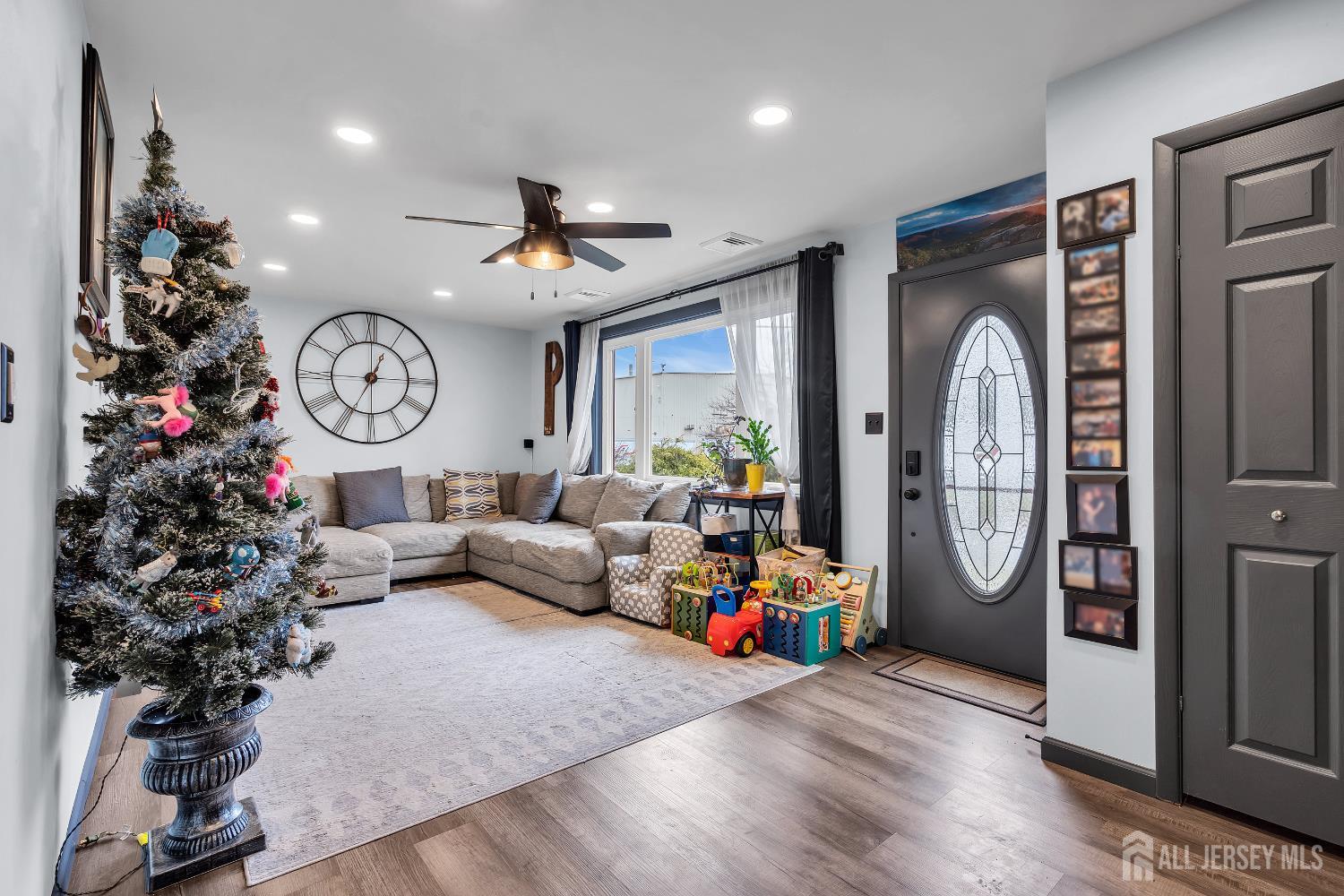505 Summit Street Hightstown, NJ 08520 - Photo 4 of 30 a living room with furniture a clock and a large window