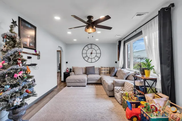 a living room with lots of furniture and a large window