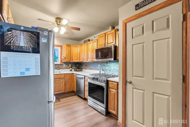a kitchen with stainless steel appliances granite countertop a stove and a refrigerator