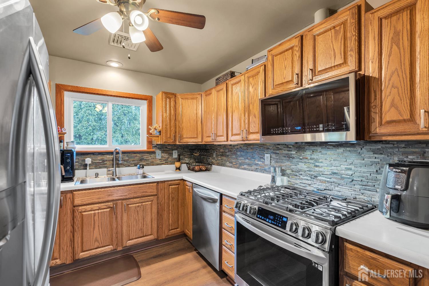 505 Summit Street Hightstown, NJ 08520 - Photo 8 of 30 a kitchen with a stove a sink and a microwave