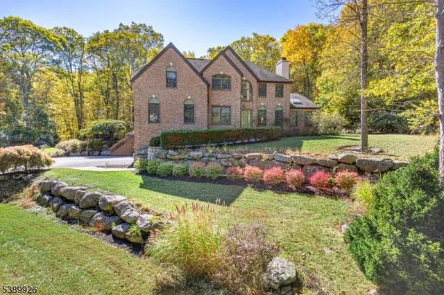 a front view of a house with a garden and plants