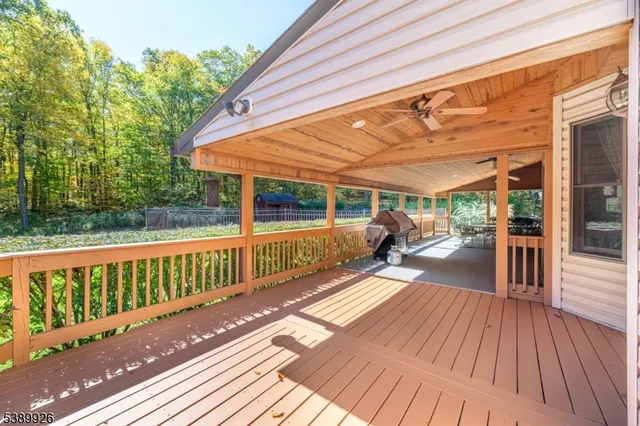 a view of a patio with table and chairs and floor to ceiling window