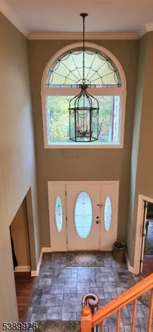 a living room with furniture a large window and bookshelf