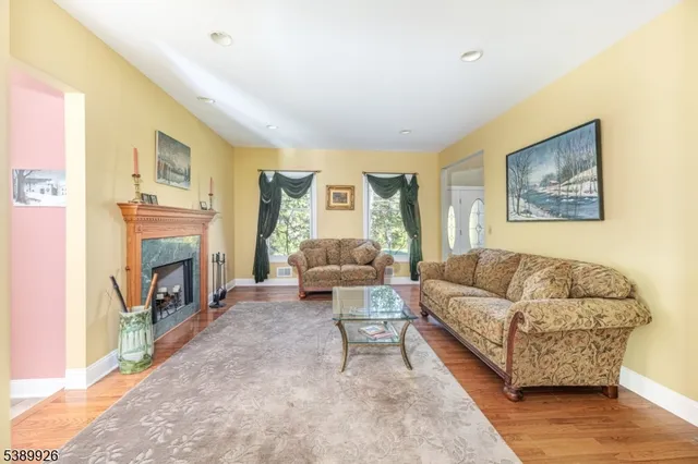 a spacious bedroom with a bed a dresser and a window