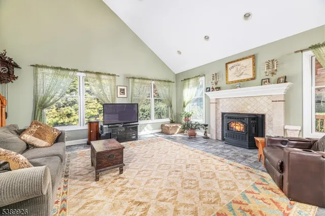 a living room with furniture large window and a fireplace