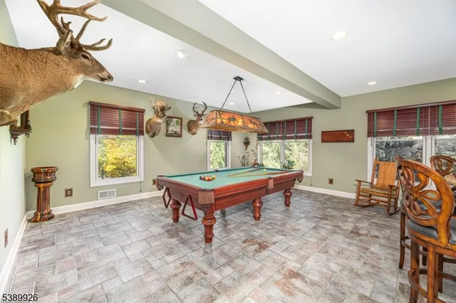 a room with pool table and a window