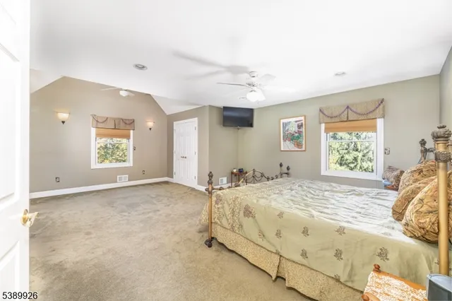 a living room with furniture and a bed