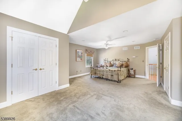 a bathroom with a sink a toilet a mirror and shower