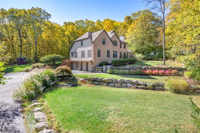 a front view of a house with a garden and yard