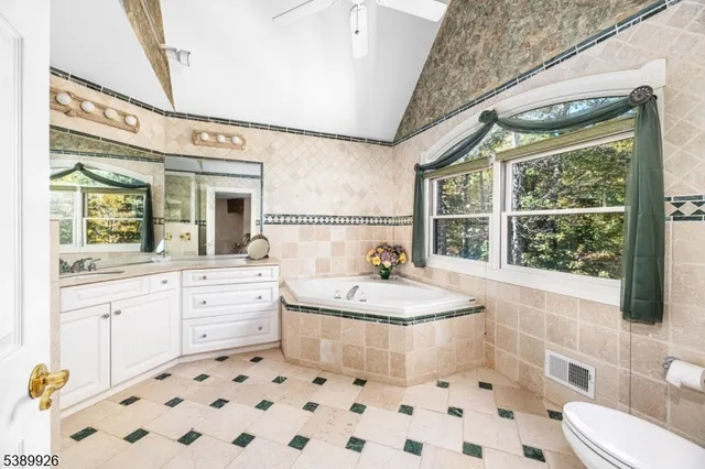 a bathroom with a tub sink and mirror