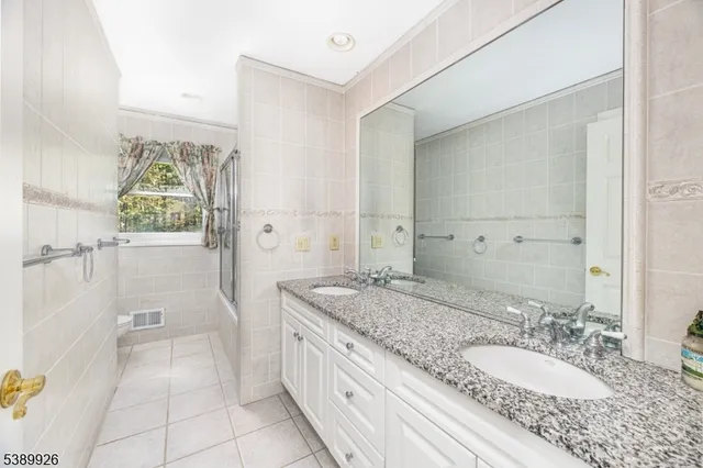 a bedroom with a bed couch and a window