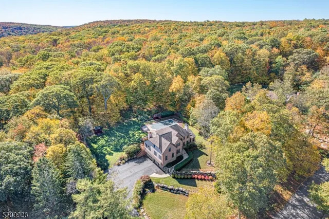 an aerial view of a house with a yard basket ball court