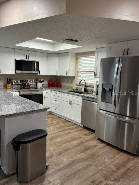 7421 Glasgow Road Weeki Wachee, FL 34613 - Photo 3 of 11 a kitchen with stainless steel appliances granite countertop a sink stove and refrigerator