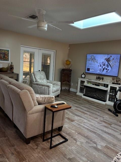 7421 Glasgow Road Weeki Wachee, FL 34613 - Photo 5 of 11 a living room with furniture a flat screen tv and a fireplace