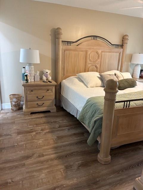 7421 Glasgow Road Weeki Wachee, FL 34613 - Photo 8 of 11 a bedroom with a bed and wooden floor