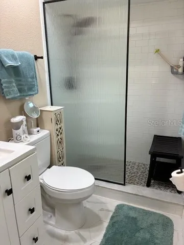 a white toilet sitting next to a bathroom sink