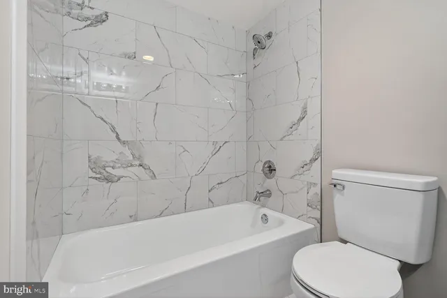 a bathroom with a toilet bathtub and shower