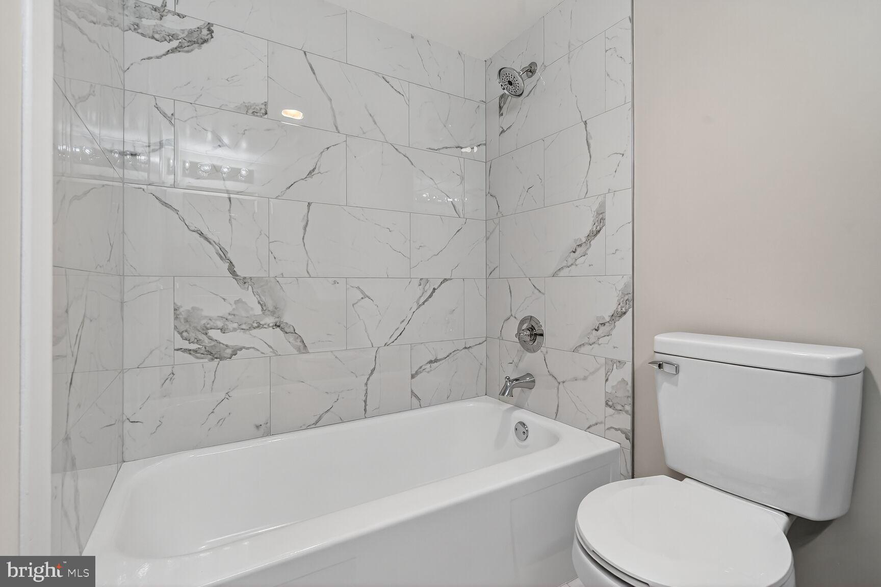 9200 Edwards Way, Unit 811 Hyattsville, MD 20783 - Photo 11 of 15 a bathroom with a toilet bathtub and shower