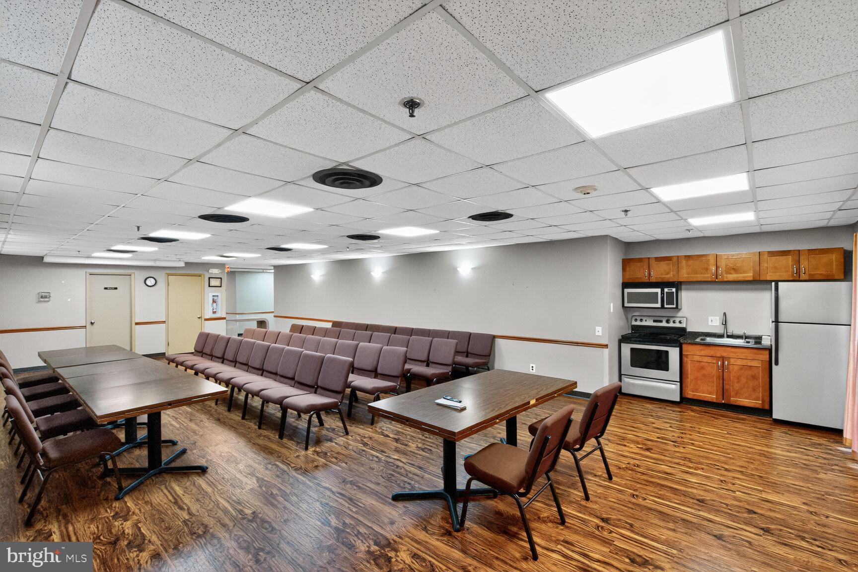 9200 Edwards Way, Unit 811 Hyattsville, MD 20783 - Photo 15 of 15 a view of a dining room with furniture and wooden floor