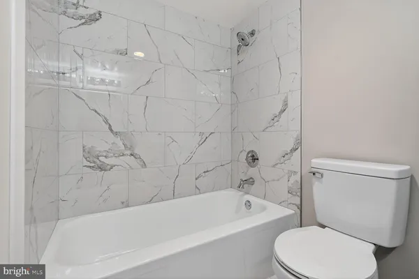 a bathroom with a toilet bathtub and shower