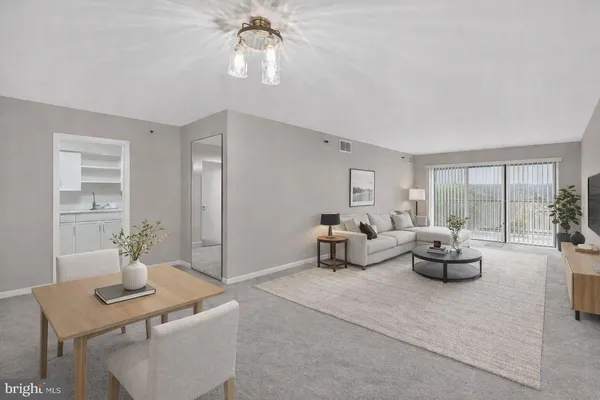 a living room with furniture and white walls