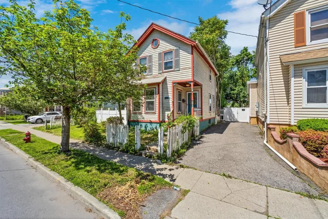 a front view of house with yard and green space