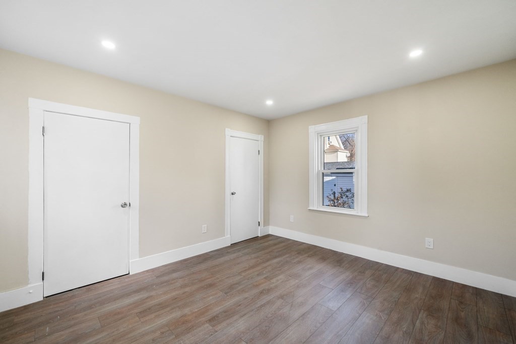 85 Barrows Street Dedham, MA 02026 - Photo 11 of 31 an empty room with wooden floor and windows