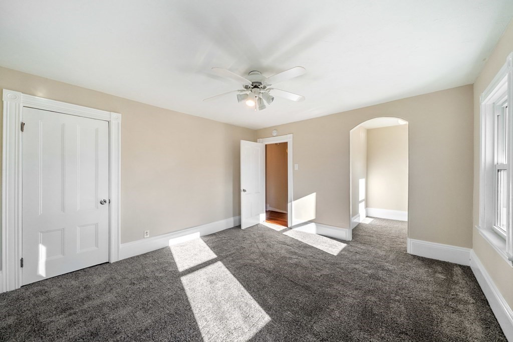 85 Barrows Street Dedham, MA 02026 - Photo 15 of 31 a view of a big room with windows and chandelier fan