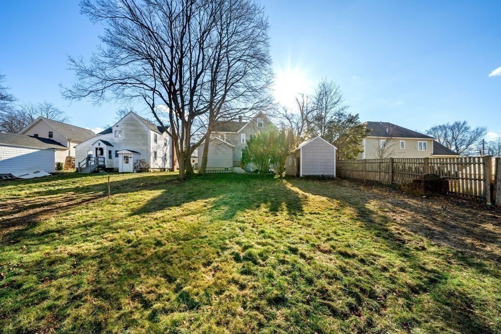 85 Barrows Street Dedham, MA 02026 - Photo 24 of 31 a view of a house with a yard