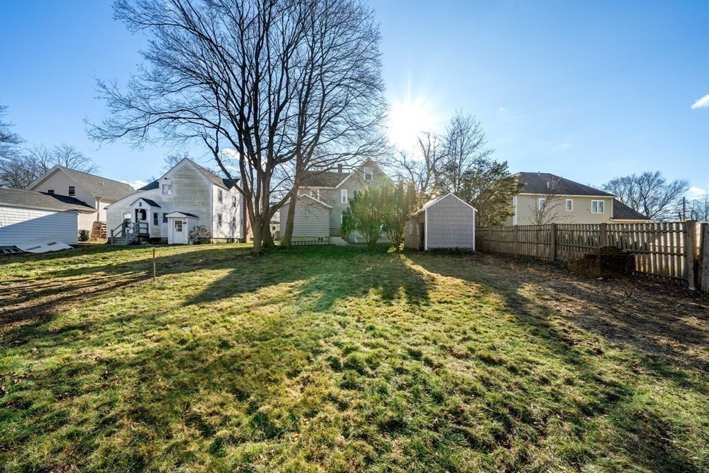 85 Barrows Street Dedham, MA 02026 - Photo 25 of 31 a view of a house with a yard