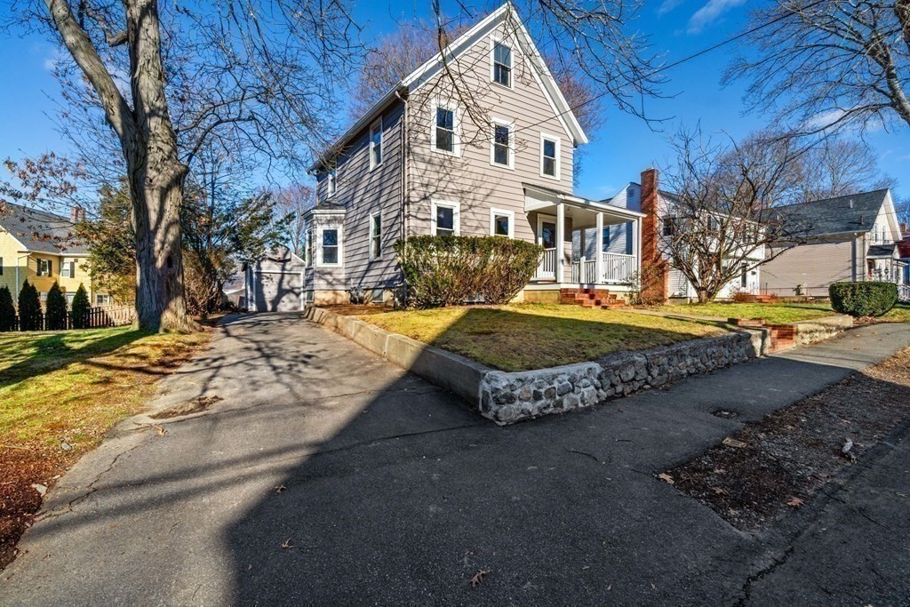 85 Barrows Street Dedham, MA 02026 - Photo 27 of 31 a view of a white house with a yard covered in snow