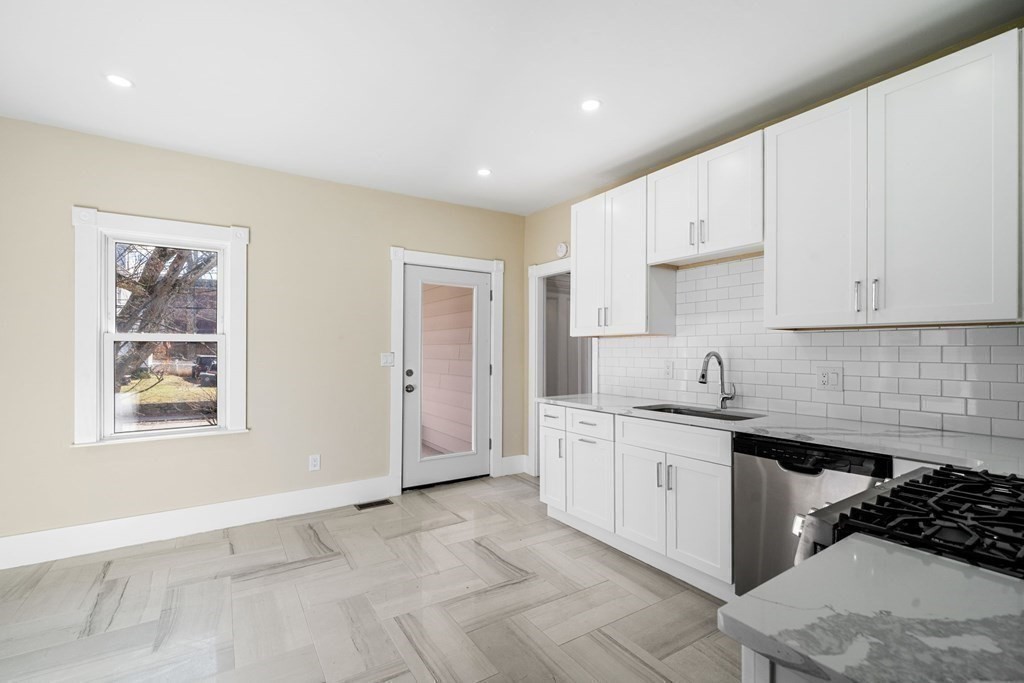 85 Barrows Street Dedham, MA 02026 - Photo 9 of 31 a kitchen with stainless steel appliances granite countertop a sink stove and cabinets