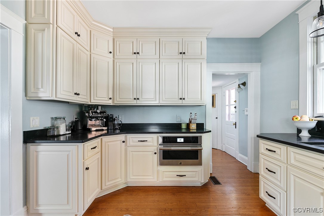 4222 Seminary Avenue Richmond, VA 23227 - Photo 27 of 50 a kitchen with granite countertop white cabinets and stainless steel appliances