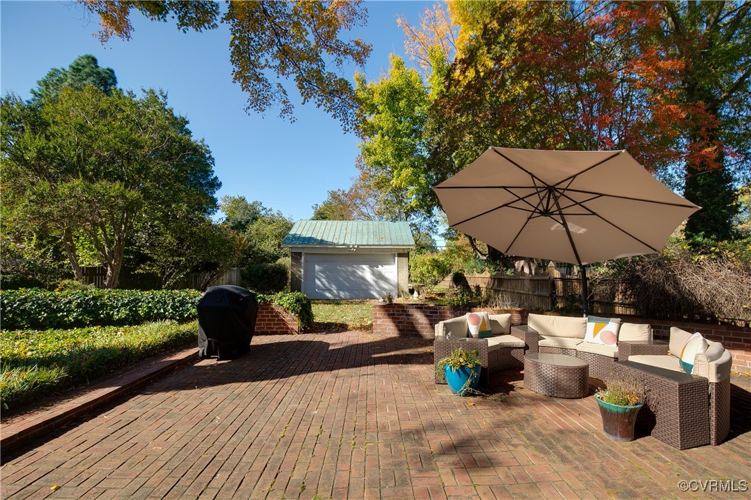 4222 Seminary Avenue Richmond, VA 23227 - Photo 46 of 50 a view of a roof deck with a table and chairs under an umbrella with a barbeque