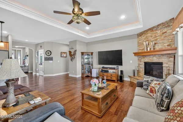 a living room with furniture a flat screen tv and a fireplace