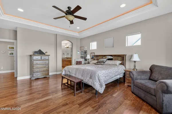 a bedroom with a bed furniture and a flat tv screen