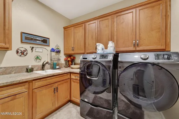 a utility room with sink dryer and washer