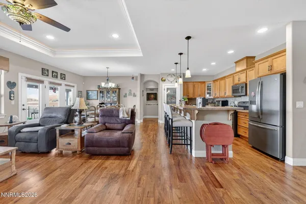 a living room with furniture a kitchen appliances and a dining table