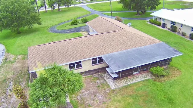 an aerial view of a house with a yard