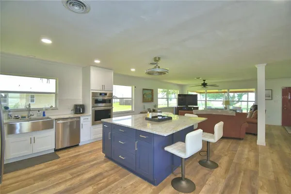 a large kitchen with lots of counter space and stainless steel appliances