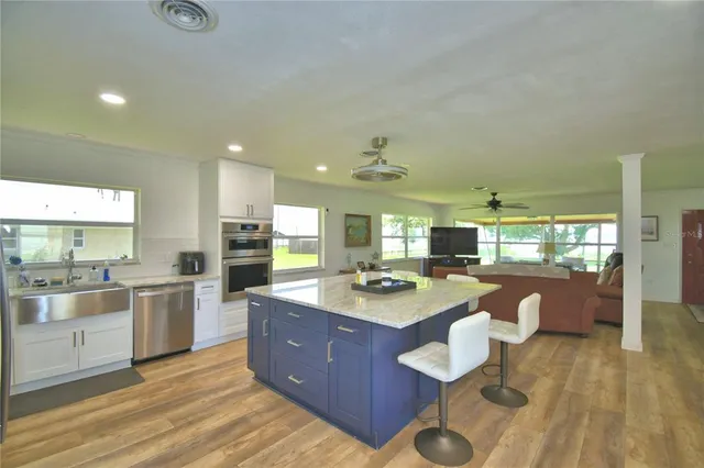 a large kitchen with lots of counter space and stainless steel appliances